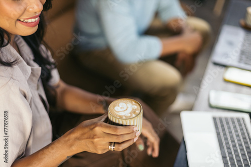 Close up of a female hand holding a cup of coffee photo