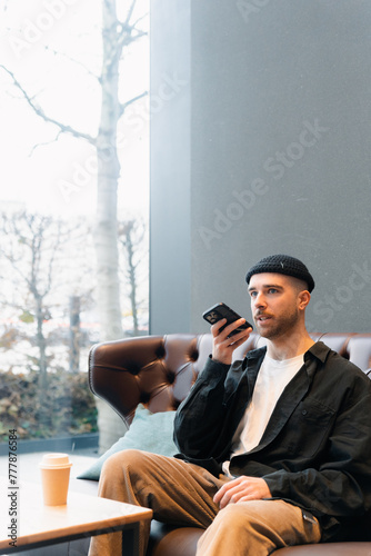 A man records a voice message on his mobile