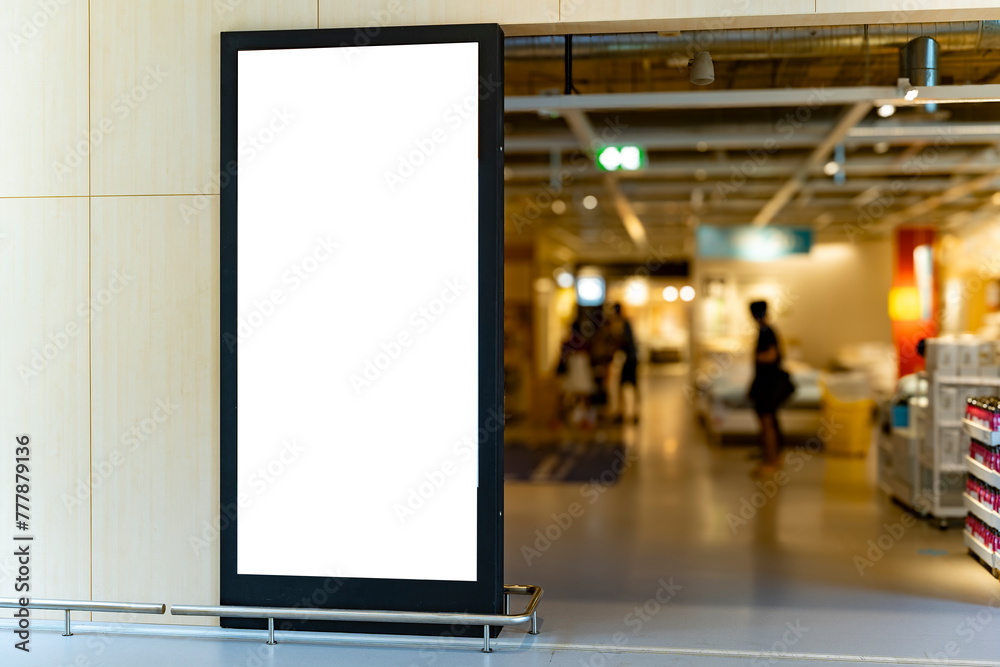 Naklejka premium Mockup vertical blank billboard with black frame at front of shoes shop