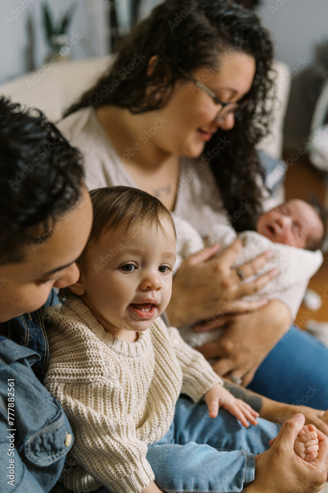 smiling mothers with newborn baby and daughter at home smiling mothers with newborn baby and daughter at home