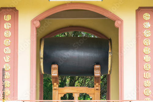 A large ancient drum suspended under an archway of an historic monastery at Da Lat in Vietnam