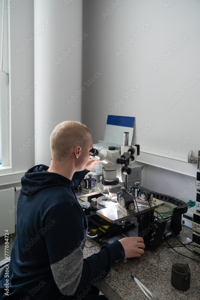 Researcher Using Microscope In Lab Room