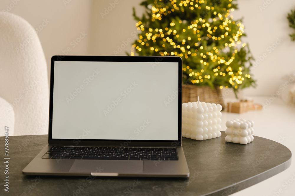 Laptop with empty screen placed on table in room Laptop with empty screen placed on table in room
