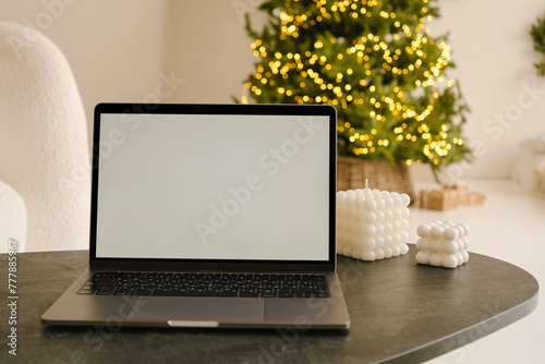 Laptop with empty screen placed on table in room photo
