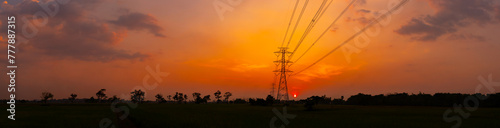 Panorama Silhouette street light post, electric pole and high voltage tower.High voltage transmission pole against evening sunset sun background.
