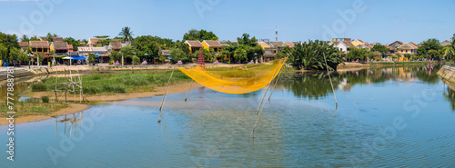 Panorama of a large fishing net suspended over a river at Hoi An in Vietnam