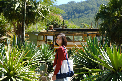 Asian girl looking up in the tropical forest photo