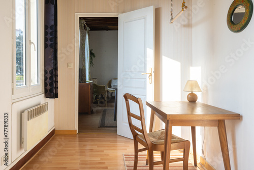 Vintage study room with wooden furniture, open window and sunlight photo