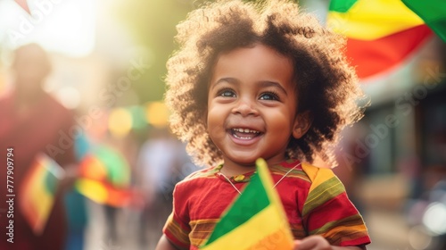 Happy Child Holding red, green and yellow flag symbolizing Juneteenth Freedom and African liberation day. Black life matters. Black history month. photo