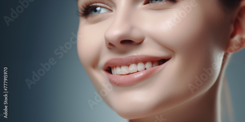 Portrait of Beautiful Smiling Young Woman with Healthy Teeth on blue gray background, Closeup