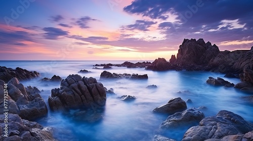 Vertical long exposure shot of the seascape in guernsey during sunset