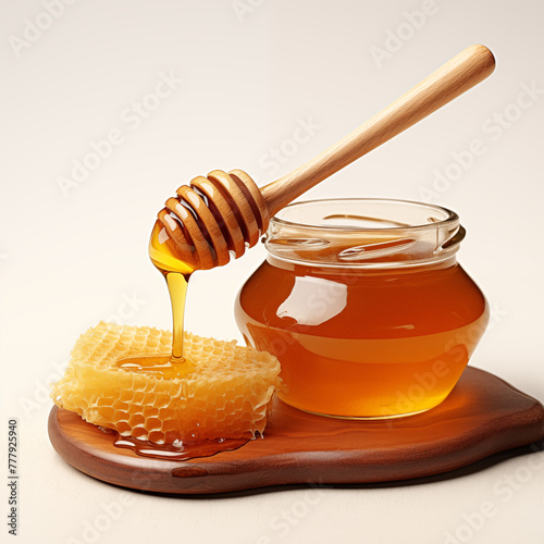 Honey with honeycomb and wooden spoon.