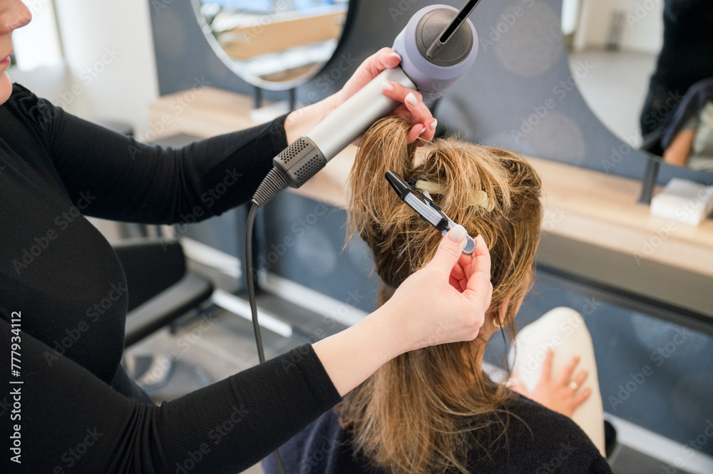 Hairdresser drying woman's hair in beauty salon Hairdresser drying woman's hair in beauty salon