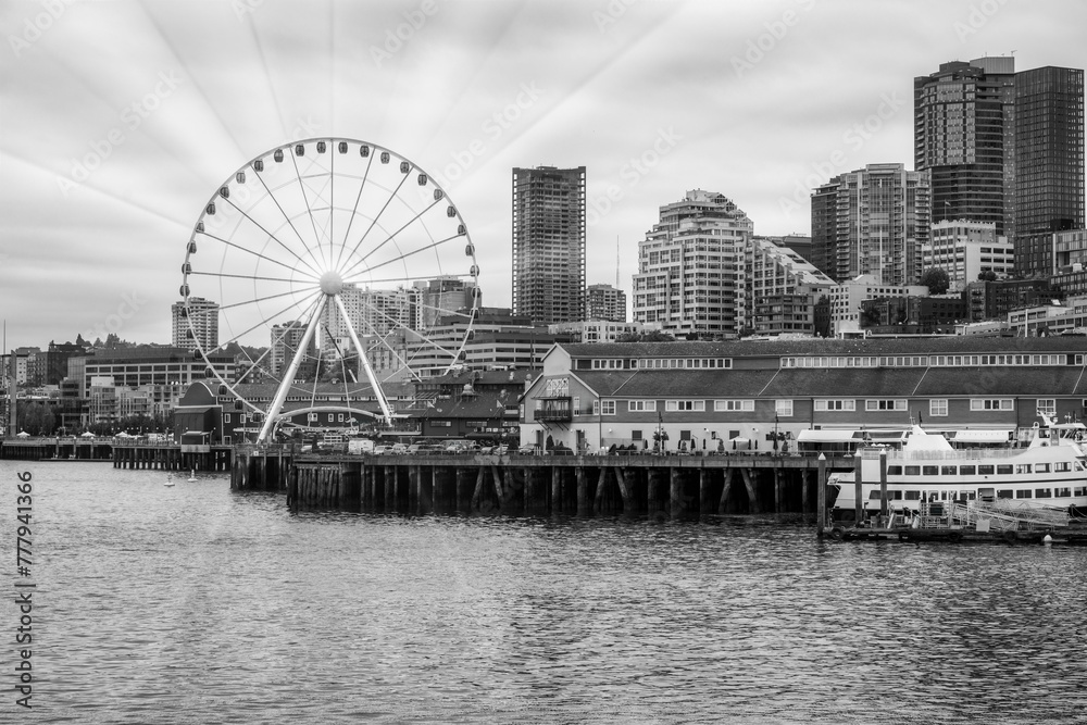 2023-12-31 THE SEATTLE WATER FRONT WITH OFFICE TOWERS THE GREAT WHEEL NEXT TO PIER 54 ON ELLIOTT BAY-