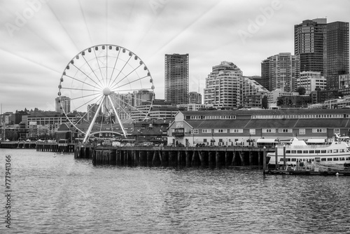 2023-12-31 THE SEATTLE WATER FRONT WITH OFFICE TOWERS THE GREAT WHEEL NEXT TO PIER 54 ON ELLIOTT BAY-