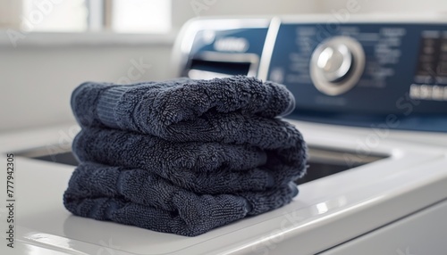 Folded Navy Towels on Top of Washing Machine.