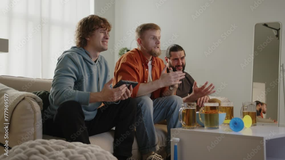 Males fan watching football match on tv, drinking and eating chips, upset with loss result. Euro 2024 in Germany. World Cup 2026 USA, Canada, Mexico. Football, sports and soccer fans. Slow Motion Males fan watching football match on tv, drinking and eating chips, upset with loss result. Euro 2024 in Germany. World Cup 2026 USA, Canada, Mexico. Football, sports and soccer fans. Slow Motion