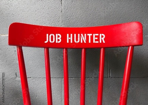 Red chair back with text written JOB HUNTER- concept of person in job hunting or seeking employment - looking for a job photo