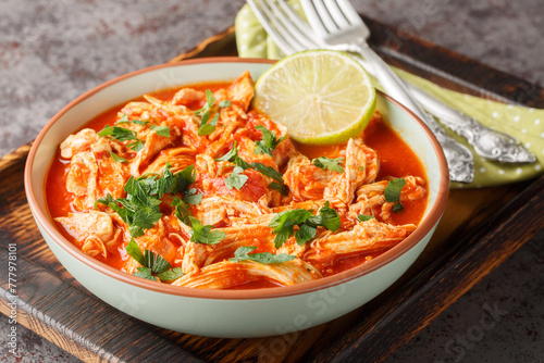 Obraz na płótnie Mexican Baked shredded Chicken and tomato salsa close-up in a bowl on a wooden board. Horizontal w salonie