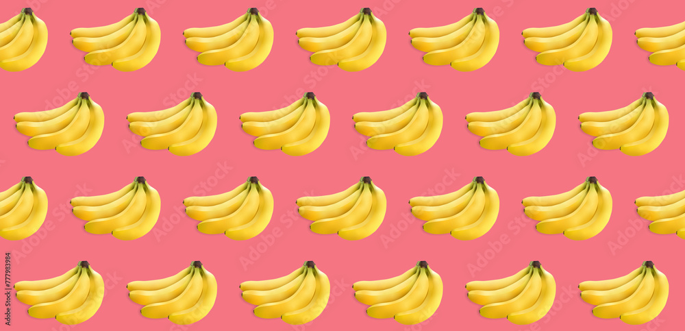 a bunch of yellow bananas on a pink texture. lots of bananas on a light texture a bunch of yellow bananas on a pink texture. lots of bananas on a light texture