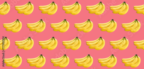 a bunch of yellow bananas on a pink texture. lots of bananas on a light texture