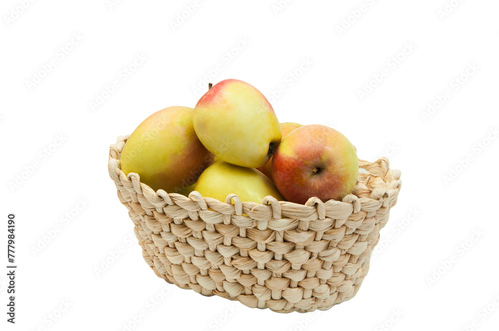 redsided apples in a wicker basket on a white background. sweet yellow apples on a light texture	