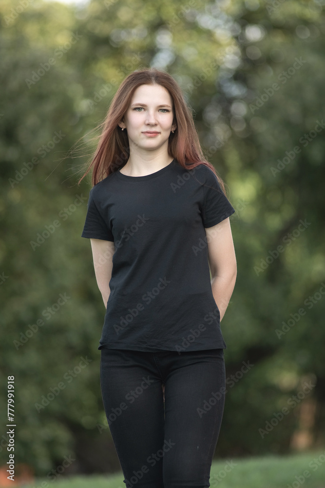 Portrait of a young beautiful long-haired girl outdoors in dark clothes. Portrait of a young beautiful long-haired girl outdoors in dark clothes.