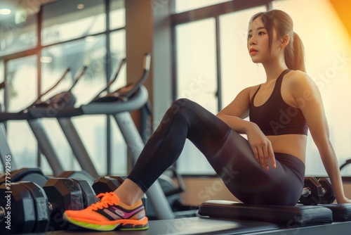 Woman Sitting on a Bench in a Gym