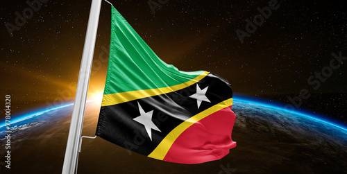 Saint Kitts and Nevis national flag cloth fabric waving on beautiful global Background. photo