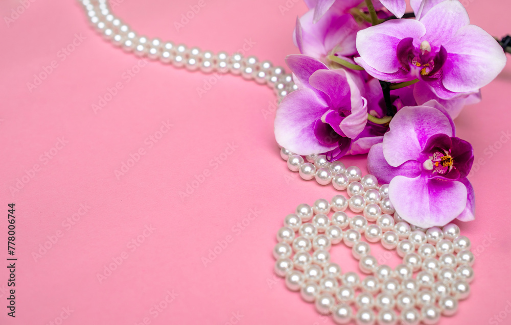 Pearl necklace and Purple orchid on pink background