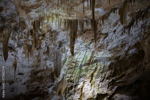 The cave is karst, amazing view of stalactites and stalagnites illuminated by bright light, a beautiful natural attraction in a tourist place.