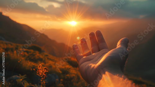 A hand reaching out towards the sun