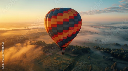 Hot Air Balloon Soaring Above Clouds © olegganko