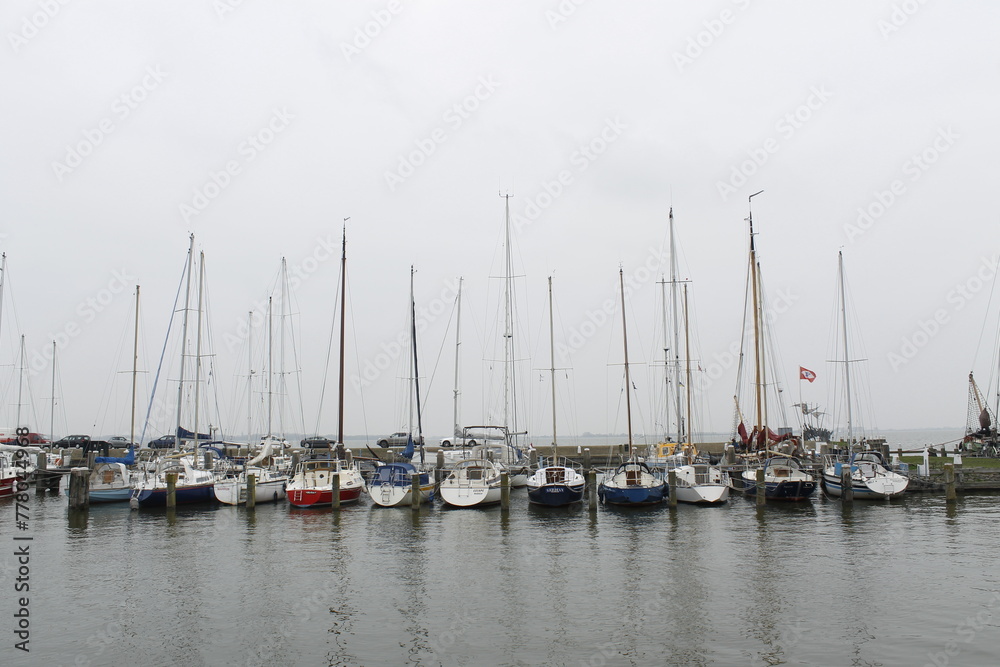 Many sailing boats moored in the port of Marken, Netherlands Many sailing boats moored in the port of Marken, Netherlands