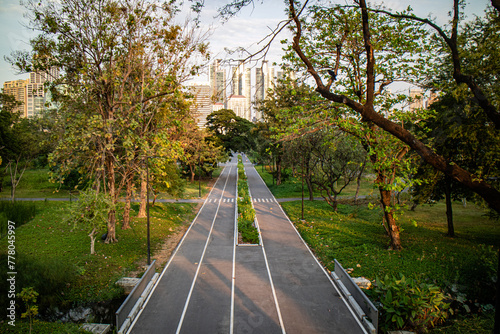 Sunset in the afternoon at Benchakitti Park. Golden hour view in the park with pathway and nature all around photo