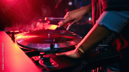 DJ works spinning turntable records at nightclub party with lively neon lights