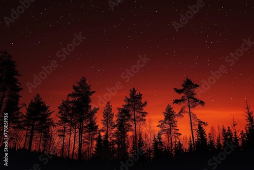 Silhouettes and Stars: Keep it simple yet stunning with a silhouette of the forest against the vibrant red sky. © Nopparat
