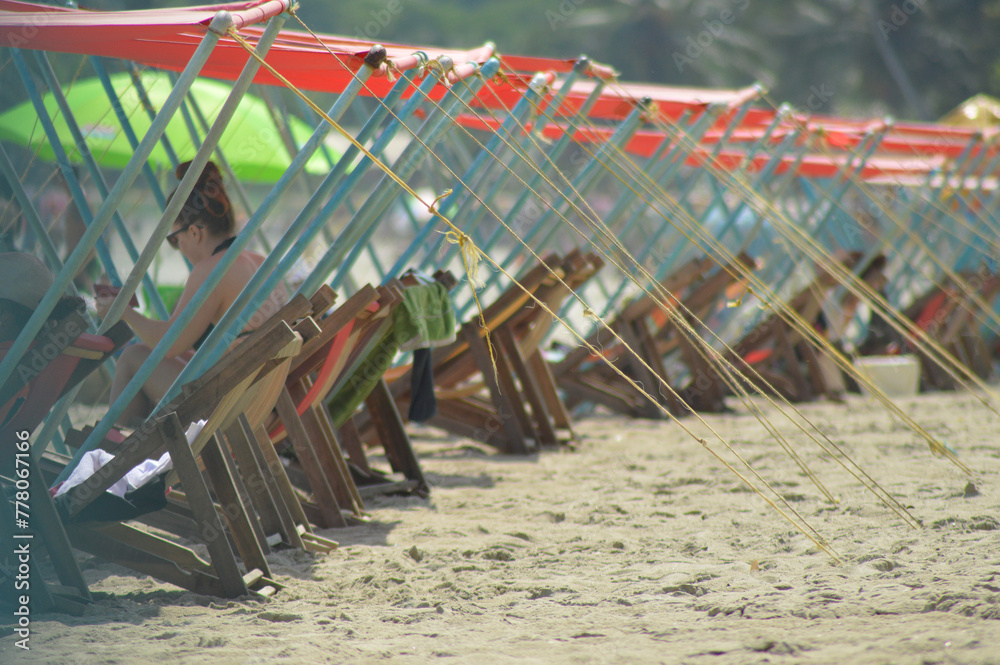 some awnings and some chairs on a beach in the Caribbean Sea