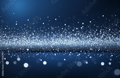 Background with blue and silver particle. bright Silver light shine particles bokeh on navy blue background. Silver foil texture. Holiday concept.