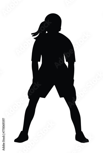 Black silhouette of a teenage girl goalkeeper of junior women's football teem in gloves who stands upright in goal and waits for the ball © ivnas