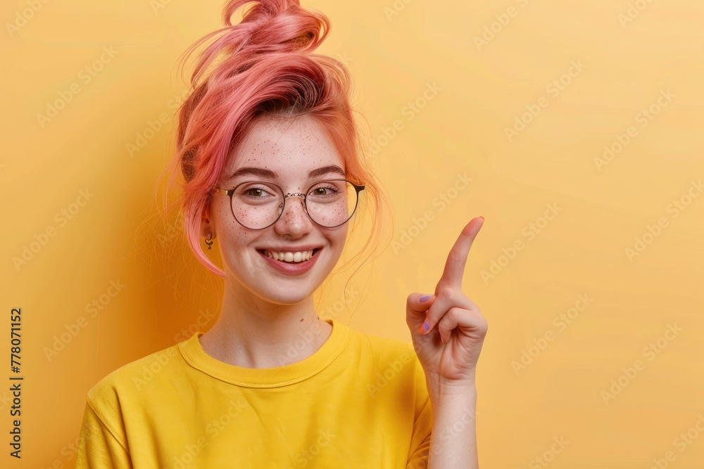 Young woman with pink dyed hair, glasses, smiling and pointing finger to empty copy space side Young woman with pink dyed hair, glasses, smiling and pointing finger to empty copy space side