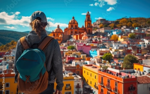 Traveler overlooks colorful cityscape © Muh