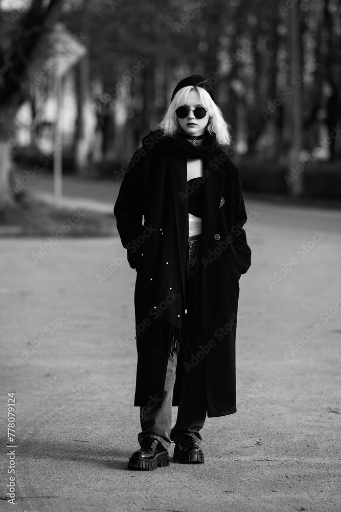 Portrait of a young beautiful blonde girl outdoors. Black and white photo. Portrait of a young beautiful blonde girl outdoors. Black and white photo.