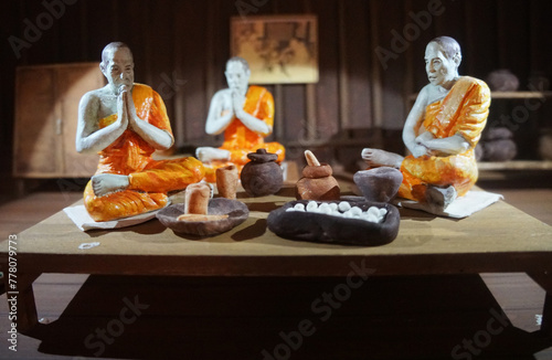 Model of Monks recite mantras for making medicine. Thai ancient compound medicine room. photo