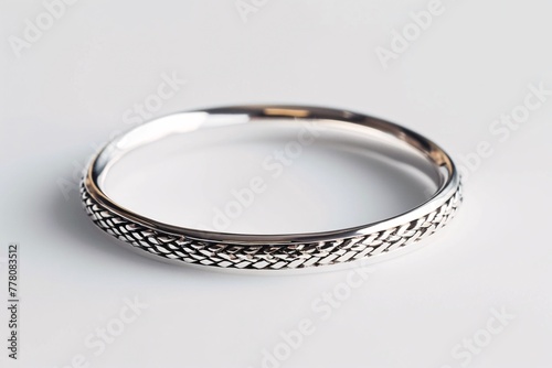 a silver ring on a white surface