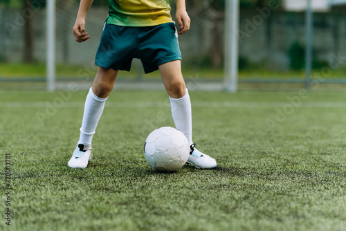 football player boy runs with the ball on the football field © Volodymyr
