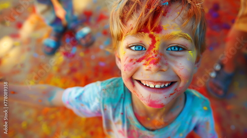 Cheerful boy at the festival of colors Holi