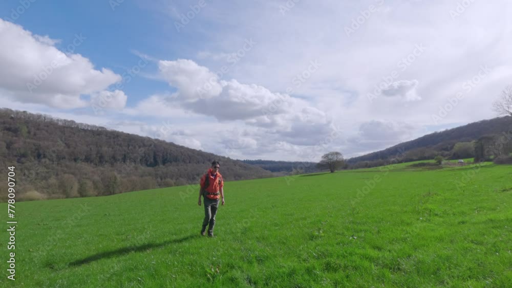 Backpacker Hiker walking in forest outdoor in Countryside of Chepstow, Wales. Spring Daytime Backpacker Hiker walking in forest outdoor in Countryside of Chepstow, Wales. Spring Daytime