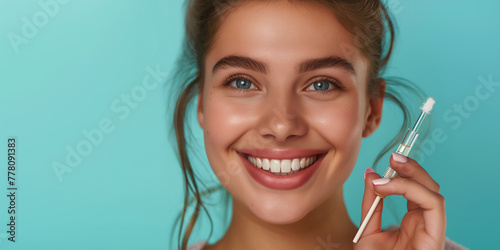 Skin care concept. Beauty portrait of smiling young woman girl holding pipette with cosmetic oil or serum near clean face. Cosmetology and Spa on teal color background professional photography
