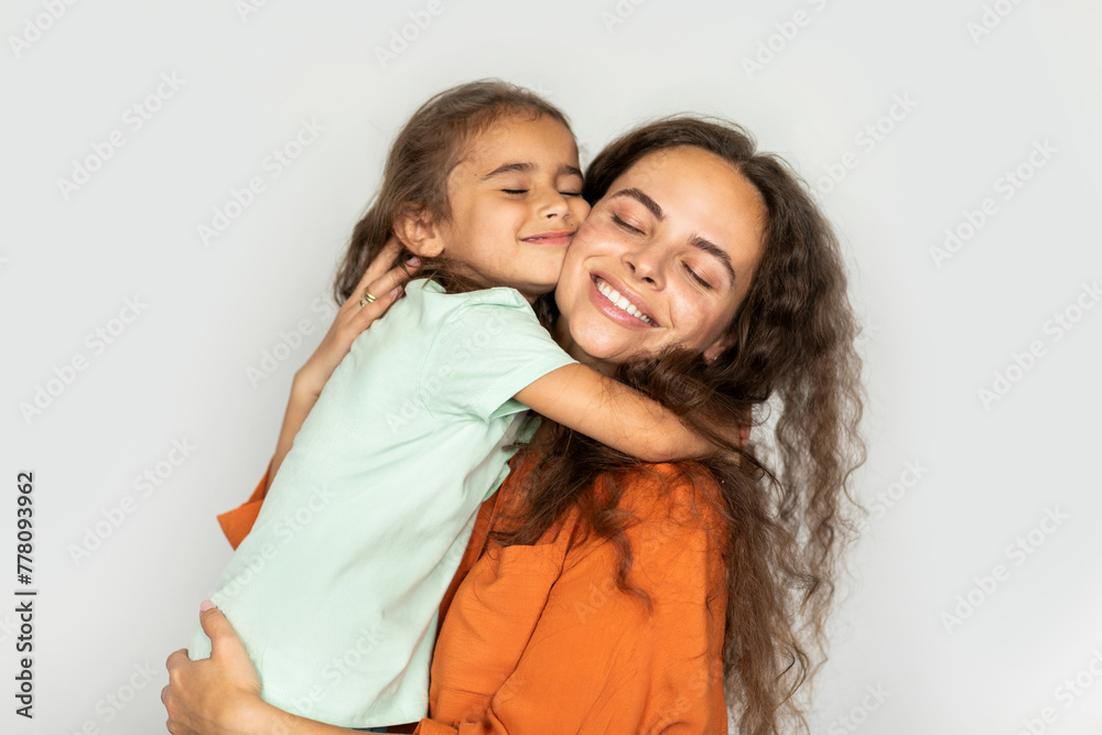 Mother daughter love. Happy mom hugging with her child girl at home, bonding and enjoying spending time with each other Mother daughter love. Happy mom hugging with her child girl at home, bonding and enjoying spending time with each other